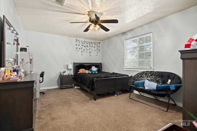 bedroom featuring ceiling fan, carpet, and a textured ceiling