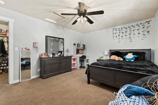 carpeted bedroom with a textured ceiling and ceiling fan