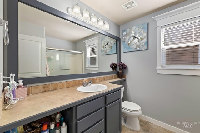 bathroom with vanity, toilet, and an enclosed shower