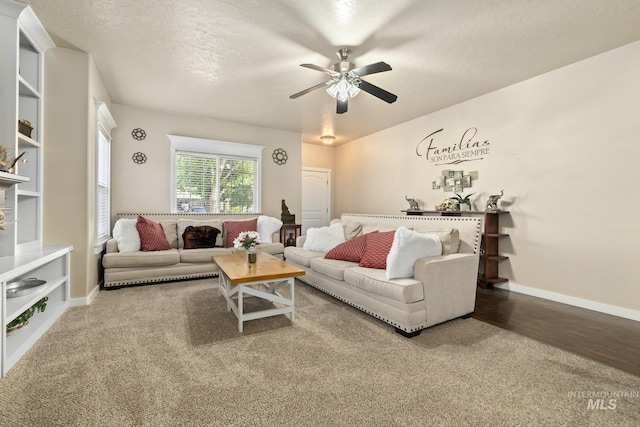 living room featuring a textured ceiling, wood-type flooring, and ceiling fan