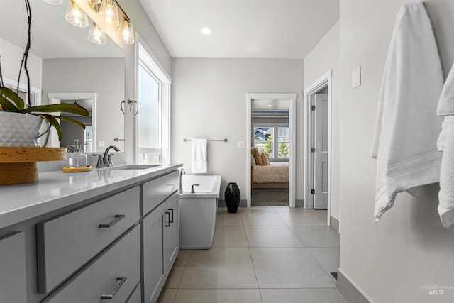 3067 N Sun City Ave, Star, ID 83669 - ensuite bathroom featuring vanity, a freestanding tub, and tile patterned flooring