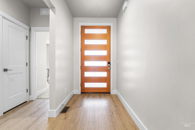 3067 N Sun City Ave, Star, ID 83669 - doorway to outside featuring light wood-style flooring and baseboards
