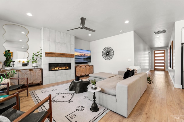 3067 N Sun City Ave, Star, ID 83669 - living area featuring ceiling fan, light wood-type flooring, a tile fireplace, and recessed lighting
