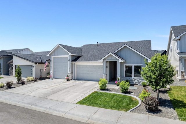 3067 N Sun City Ave, Star, ID 83669 - view of front of house with board and batten siding, a garage, roof with shingles, driveway, and stone siding