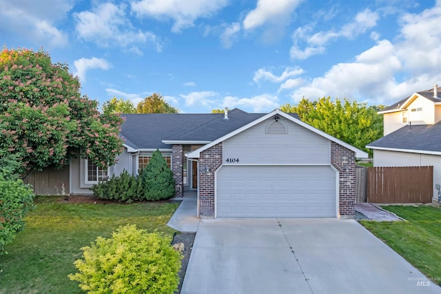 4104 Iris Ct, Nampa, ID 83687 - ranch-style house with brick siding, a garage, and driveway