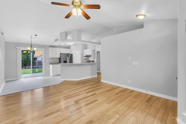 4104 Iris Ct, Nampa, ID 83687 - unfurnished living room with lofted ceiling, light wood-style floors, ceiling fan, a chandelier, and baseboards