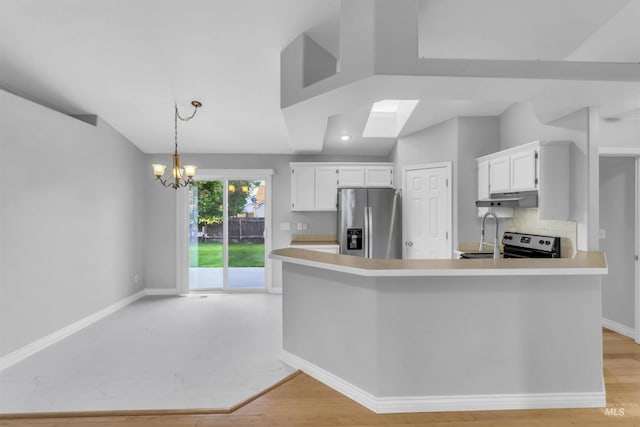 4104 Iris Ct, Nampa, ID 83687 - kitchen with stainless steel fridge with ice dispenser, electric range oven, under cabinet range hood, light countertops, and decorative backsplash