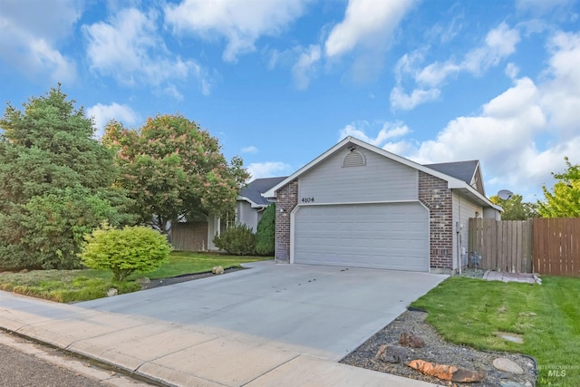 4104 Iris Ct, Nampa, ID 83687 - ranch-style home with brick siding, an attached garage, and driveway