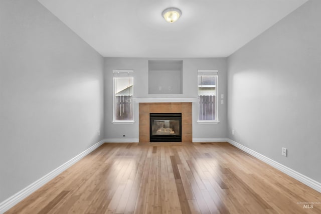 4104 Iris Ct, Nampa, ID 83687 - unfurnished living room with a fireplace, light wood-style floors, and baseboards