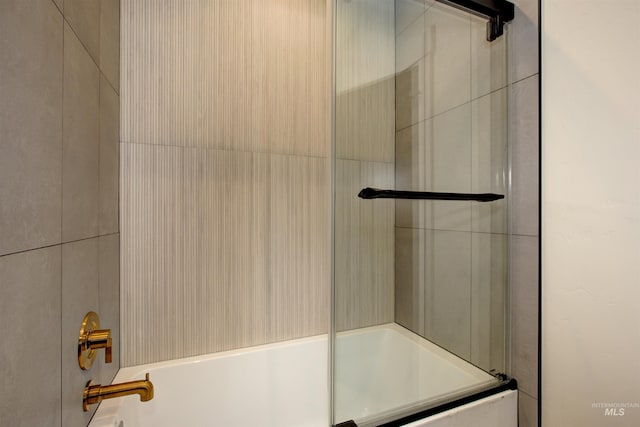 full bath featuring bath / shower combo with glass door