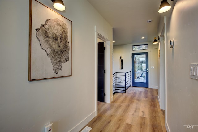 hall featuring visible vents, recessed lighting, light wood-type flooring, and baseboards