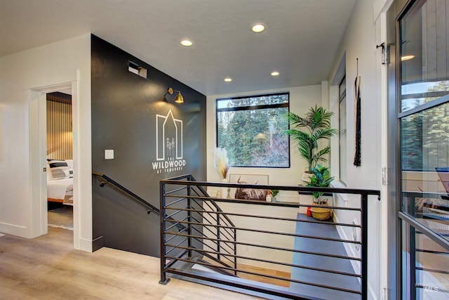 interior space featuring an upstairs landing, recessed lighting, and wood finished floors