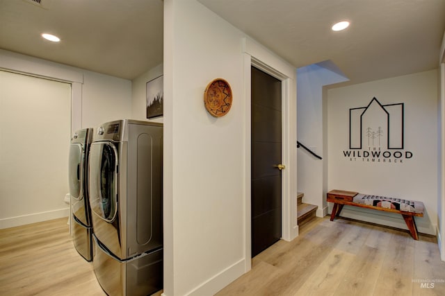 laundry area with baseboards, light wood finished floors, washing machine and clothes dryer, laundry area, and recessed lighting