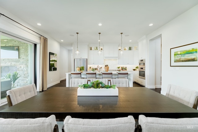 dining space featuring dark wood-type flooring