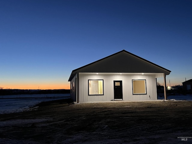 view of back of property at dusk