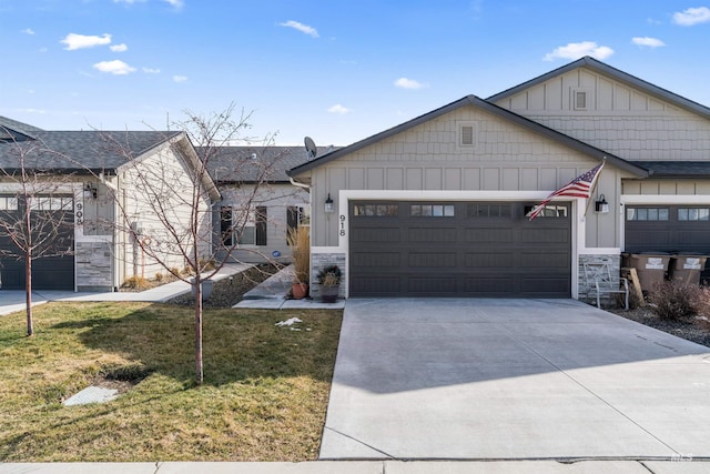 view of front of home featuring a garage, driveway, stone siding, a front lawn, and board and batten siding