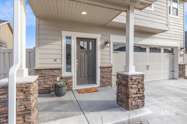 7566 W Corona Dr, Boise, ID 83709 - property entrance featuring stone siding, a garage, and driveway