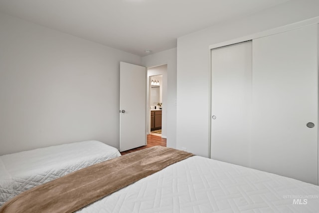 bedroom with a closet and wood finished floors