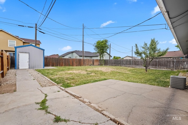 view of yard with central air condition unit, a patio, and a fenced backyard