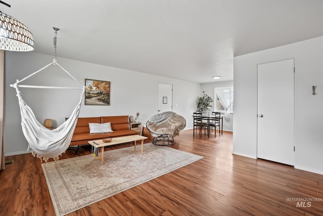 living room featuring baseboards and wood finished floors