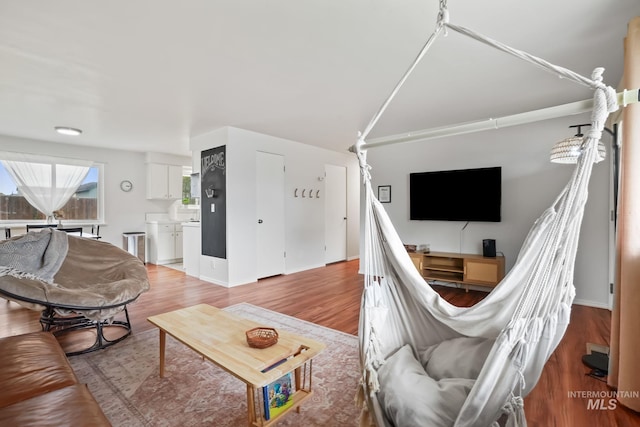 living area with baseboards and light wood-style flooring