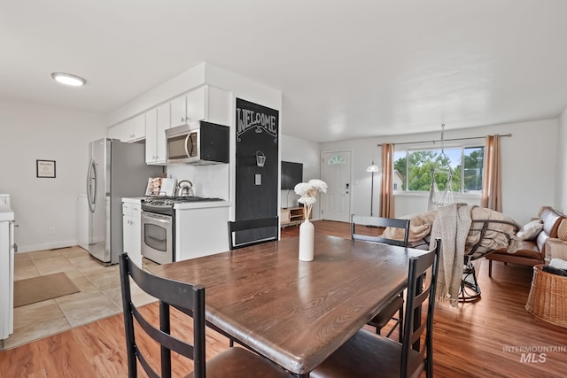 dining area with light wood-style floors