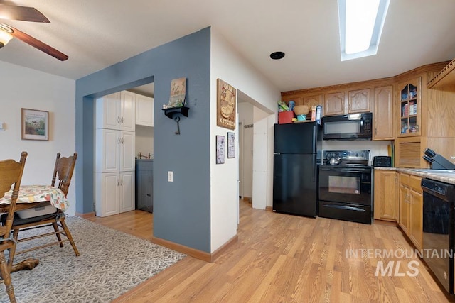 1015 E Park, Weiser, ID 83672 - kitchen with black appliances, light wood-style floors, glass insert cabinets, a ceiling fan, and light countertops