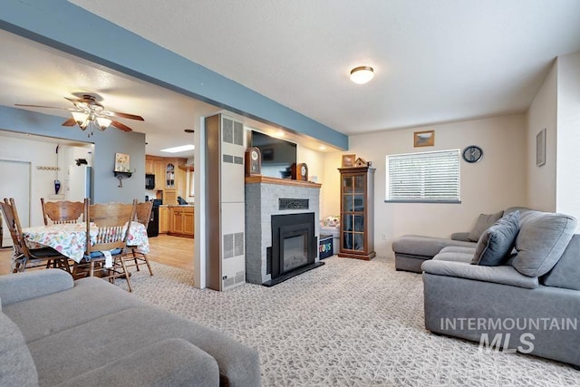 1015 E Park, Weiser, ID 83672 - carpeted living room featuring a glass covered fireplace and ceiling fan