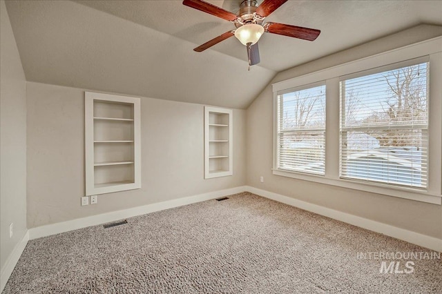 1512 N 28th St, Boise, ID 83703 - carpeted empty room featuring vaulted ceiling, baseboards, built in shelves, and a ceiling fan