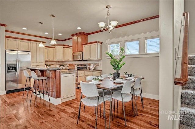 1512 N 28th St, Boise, ID 83703 - dining area featuring ornamental molding, stairway, light wood-style flooring, baseboards, and a chandelier