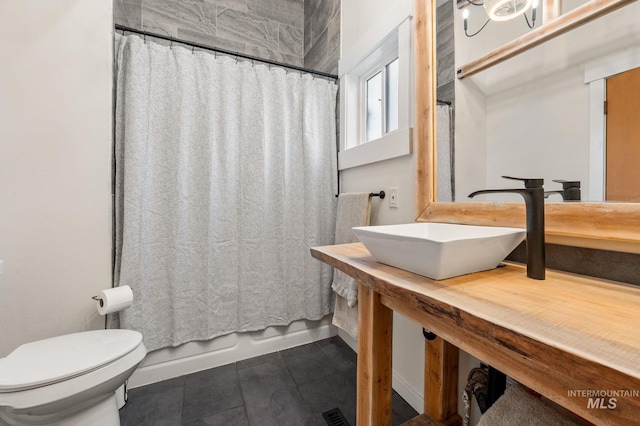 bathroom featuring toilet and sink