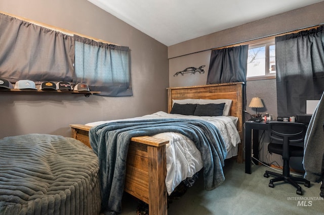 bedroom with carpet floors and lofted ceiling