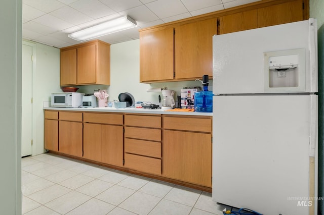 kitchen featuring white appliances and light tile patterned floors