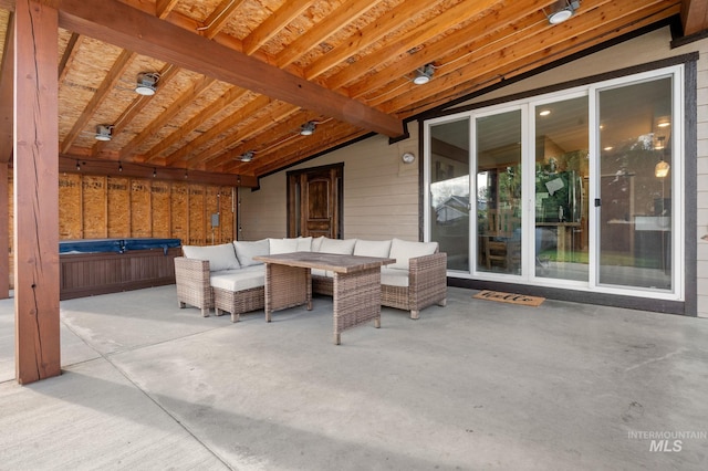 view of patio / terrace with outdoor lounge area and a hot tub