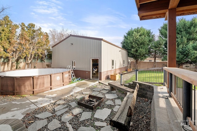 view of patio with a fire pit and a fenced in pool