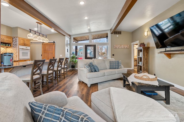 living room featuring dark hardwood / wood-style floors, a barn door, and lofted ceiling with beams