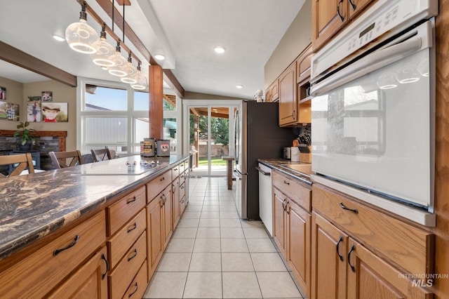 kitchen featuring pendant lighting, dishwasher, white oven, decorative backsplash, and light tile patterned floors