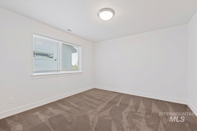 carpeted empty room with baseboards and visible vents