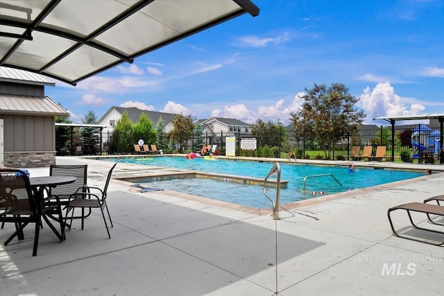 pool with fence and a patio