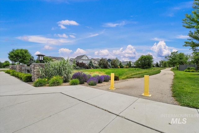 view of home's community featuring a yard and a residential view