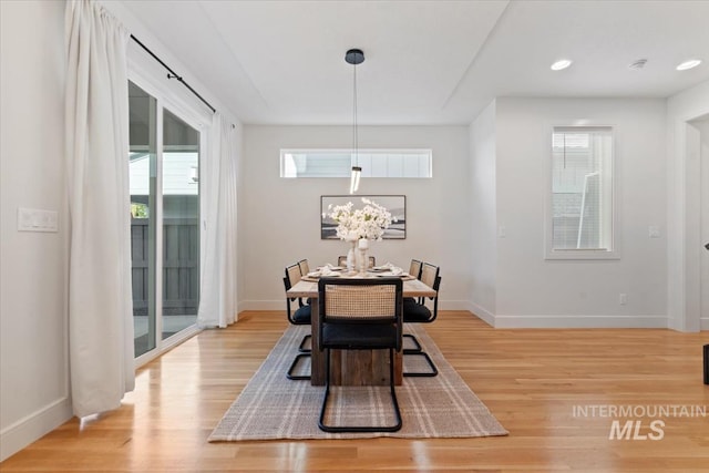 dining space featuring baseboards, recessed lighting, light wood-style flooring, and a wealth of natural light