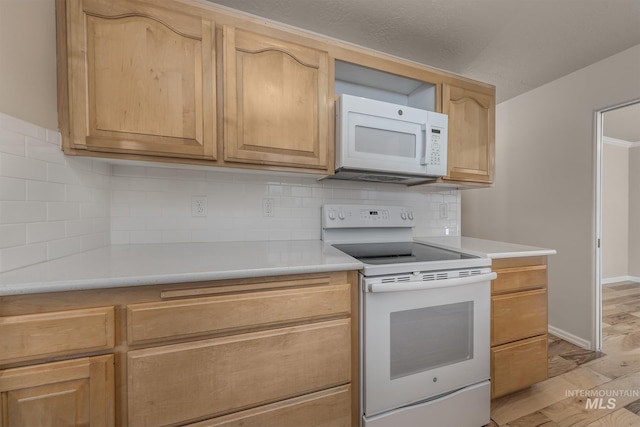 kitchen with decorative backsplash, light brown cabinets, white appliances, and light hardwood / wood-style flooring