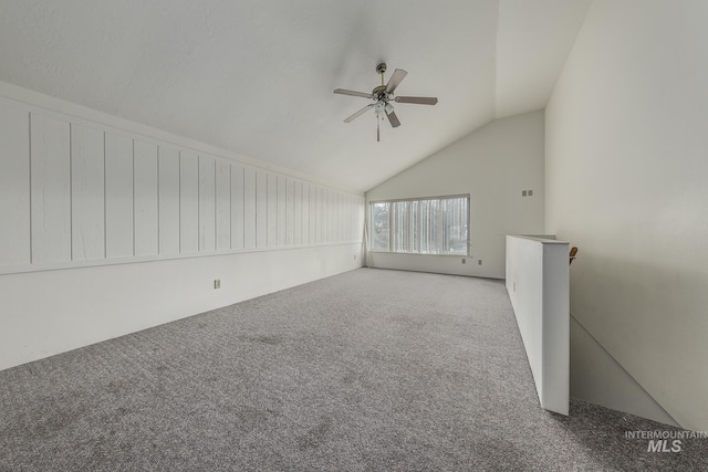 interior space with carpet, ceiling fan, and lofted ceiling