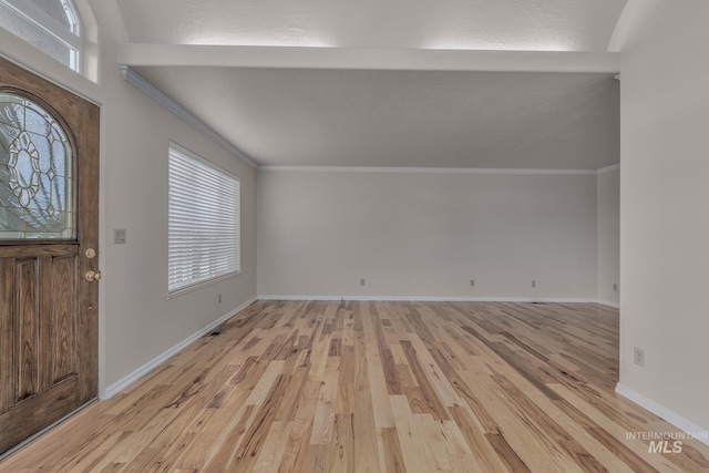 foyer with light hardwood / wood-style floors and ornamental molding