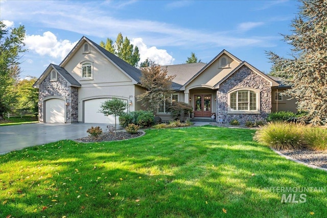 view of front of home with a front yard and a garage