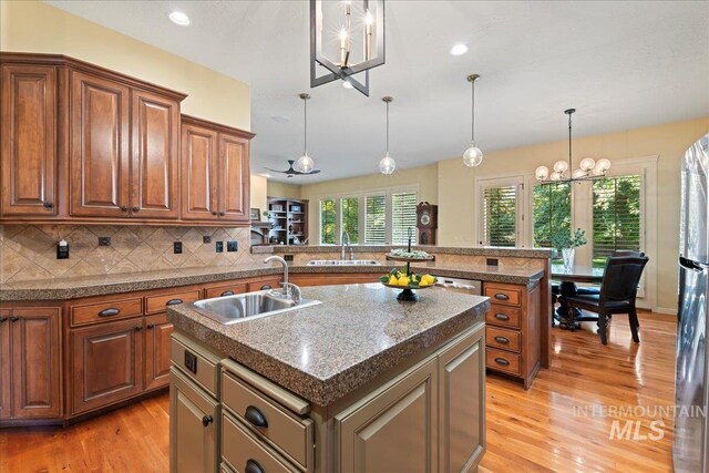 kitchen featuring light hardwood / wood-style flooring, a kitchen island, and sink