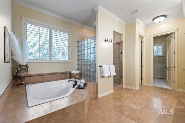 bathroom featuring independent shower and bath, crown molding, and a wealth of natural light