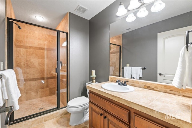 bathroom featuring vanity, walk in shower, a textured ceiling, tile patterned flooring, and toilet