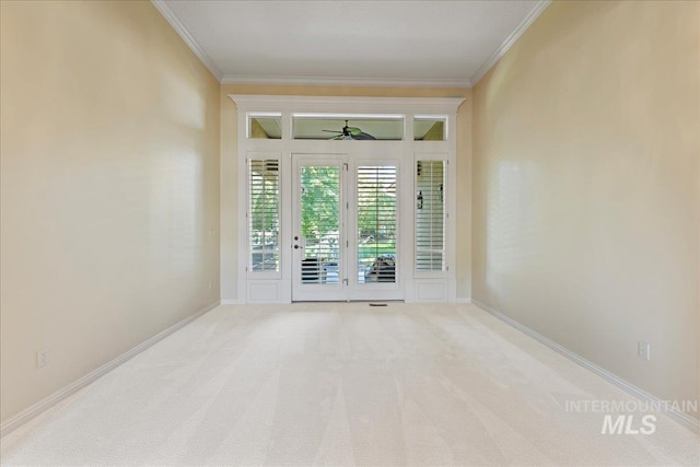 unfurnished room with ceiling fan, crown molding, and carpet flooring