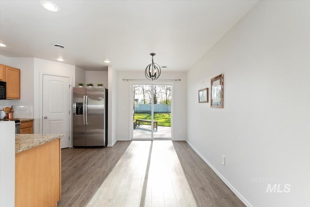 kitchen featuring light countertops, stainless steel appliances, baseboards, recessed lighting, and light wood-type flooring